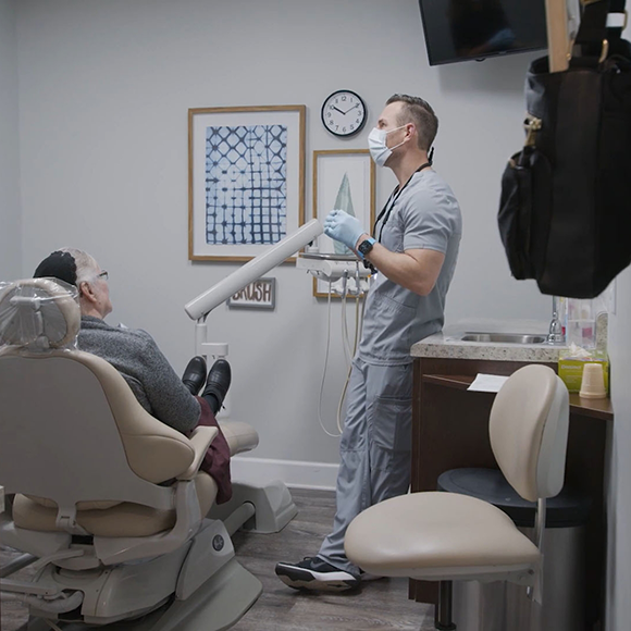 Dentist talking to a patient in the dental treatment chair