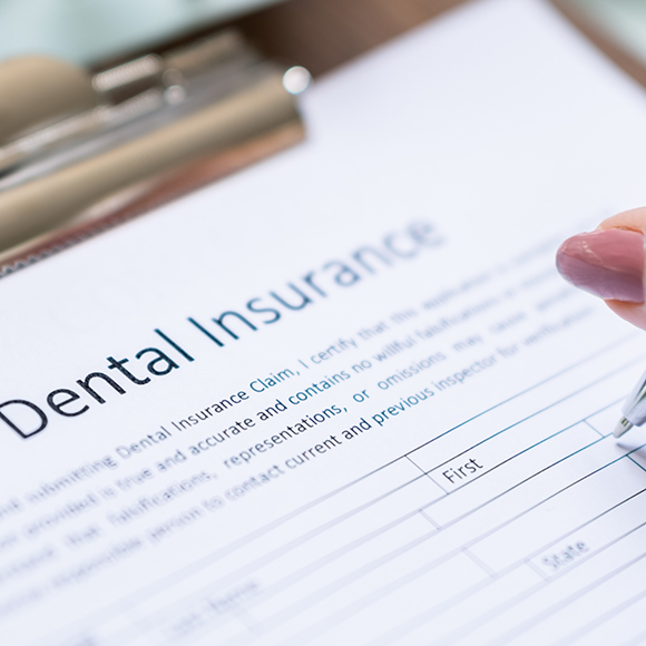 Dental insurance form on a clipboard