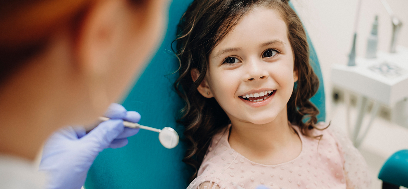 Young girl in dental chair smiling at her childrens dentist in Altavista