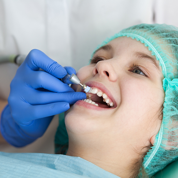 Child receiving a professional teeth cleaning