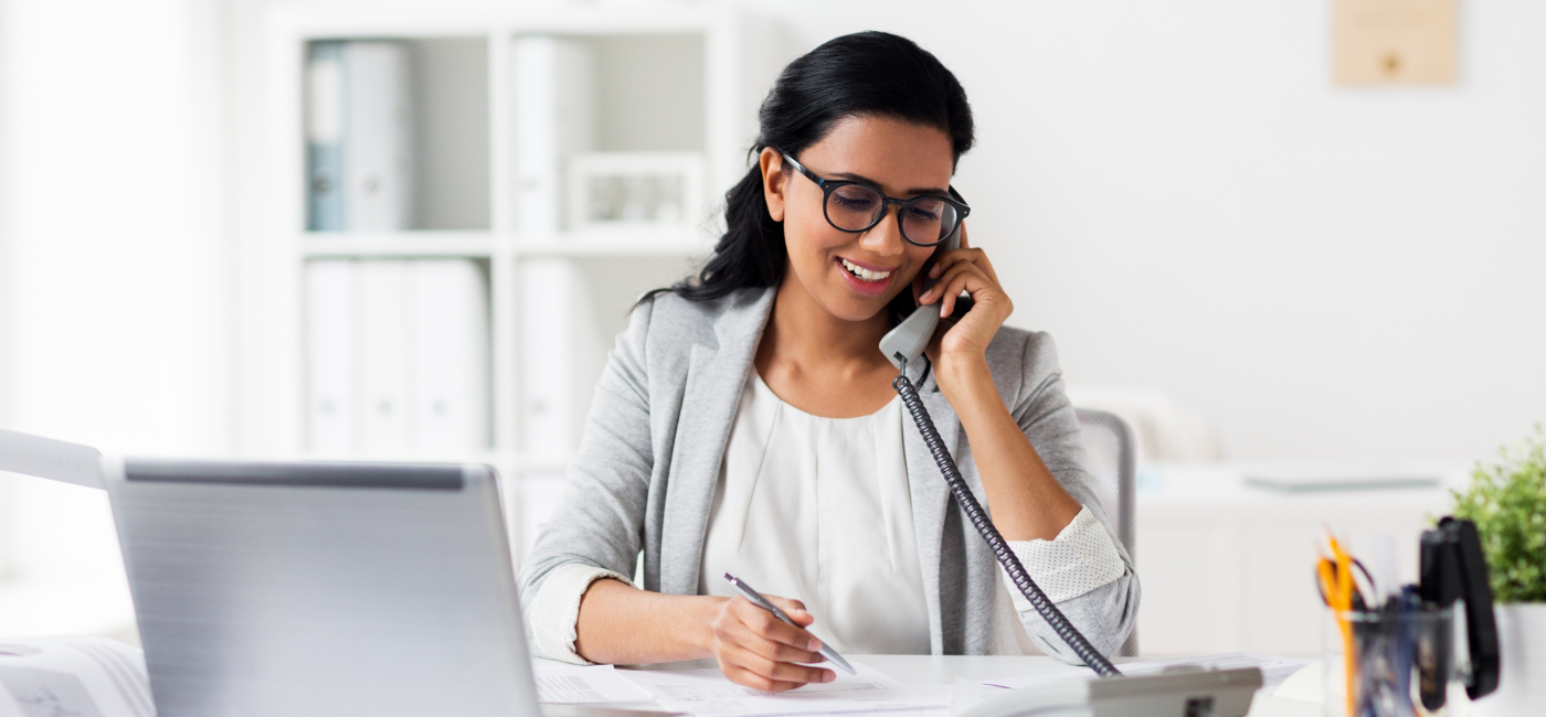 Woman talking on the phone with dental office in Altavista