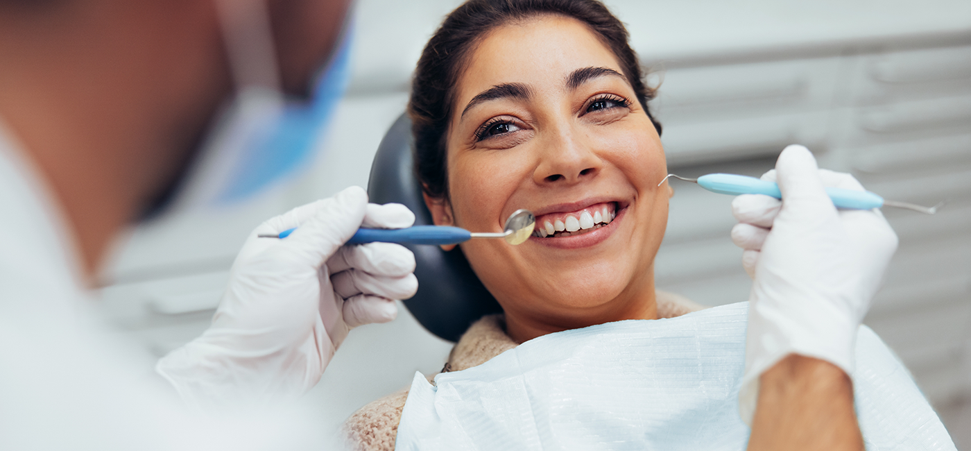 Woman smiling at her dentist during a dental checkup and cleaning in Altavista