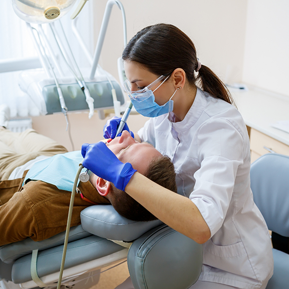 Dental hygienist giving a patient a dental cleaning