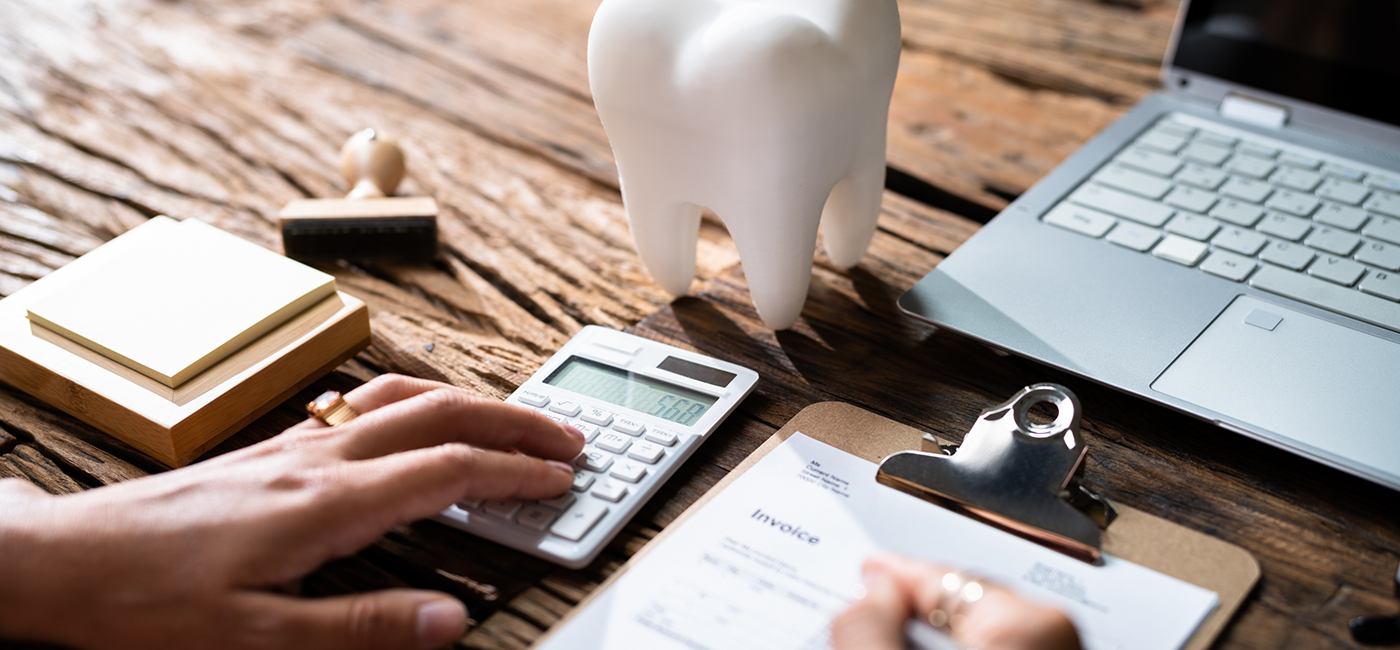 Person filling out dental insurance paperwork