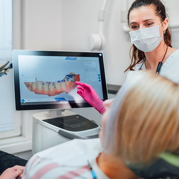 Dentist showing a patient a digital model of a row of their teeth