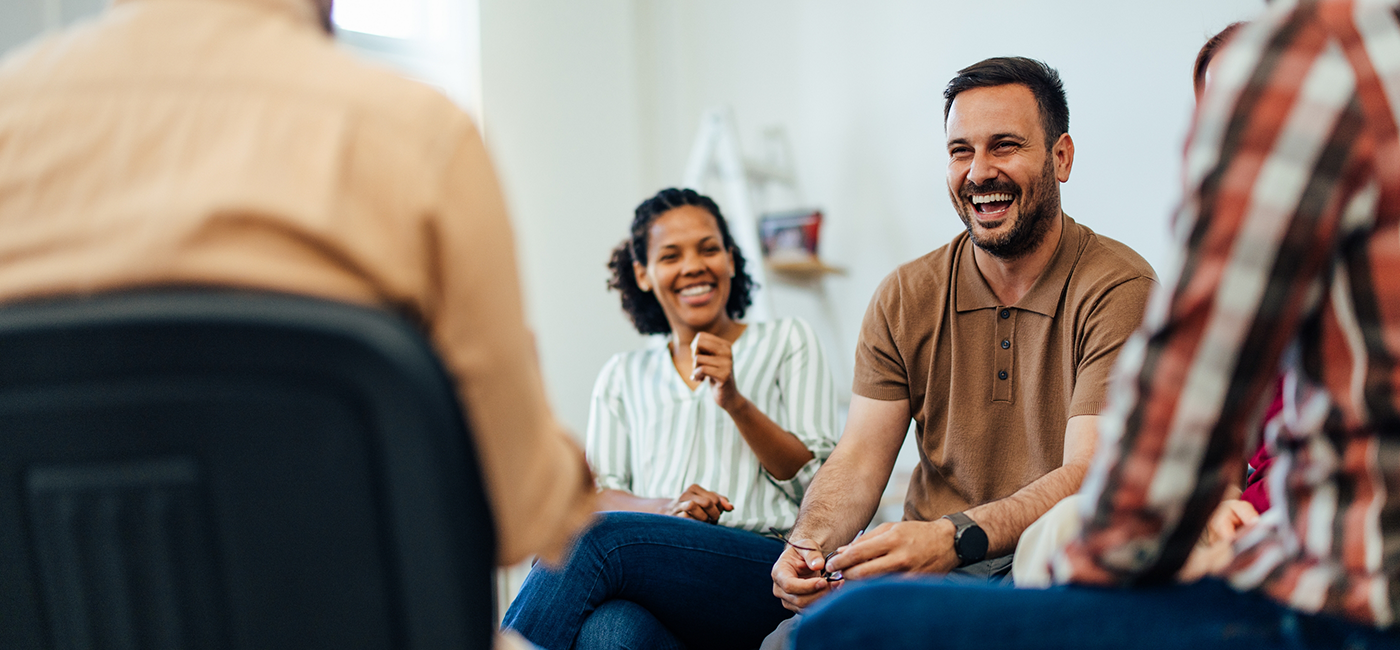 Group of adults laughing together with dentures in Altavista