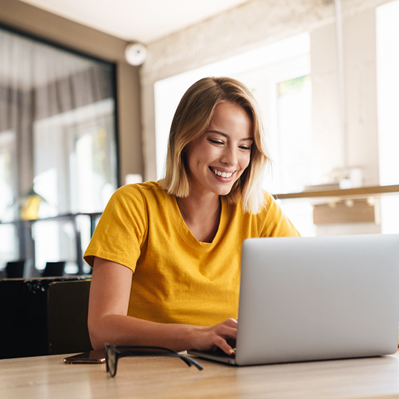 Woman smiling while using her laptop