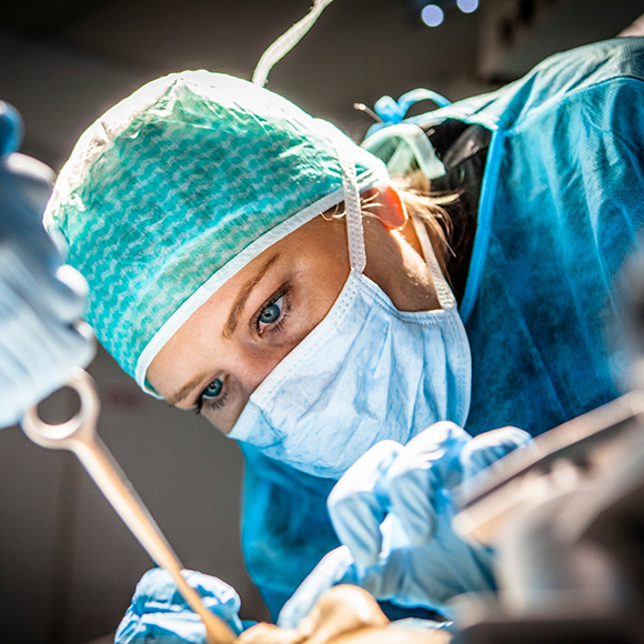 Dentist wearing a face mask while performing a dental procedure on a patient