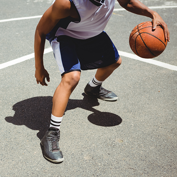 Person dribbling a basketball