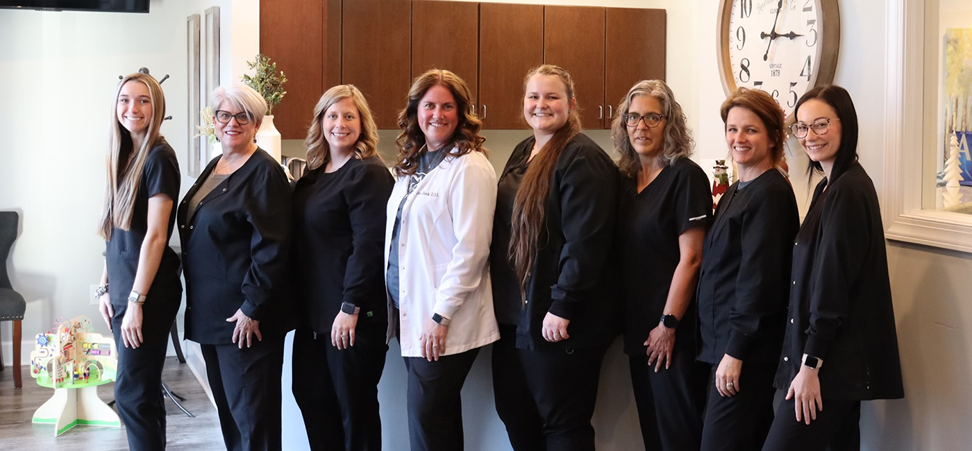 Altavista dental team members smiling in front office of Hooks Family Dentistry