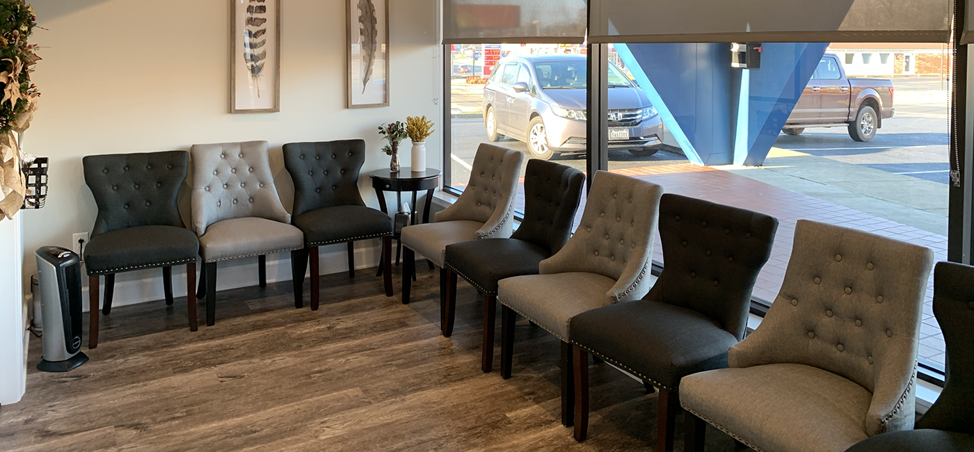 Gray chairs in waiting area of dental office in Altavista