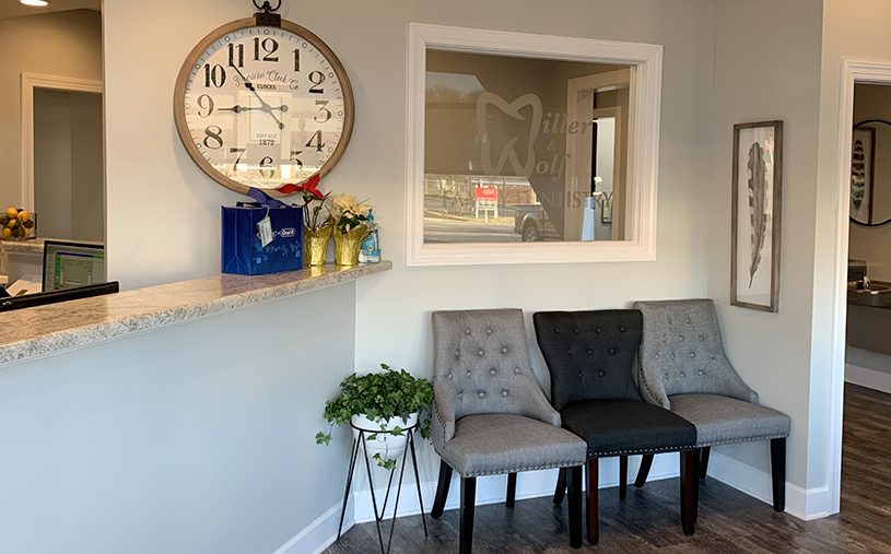 Three gray chairs next to front desk