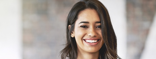 Young woman with long dark hair smiling