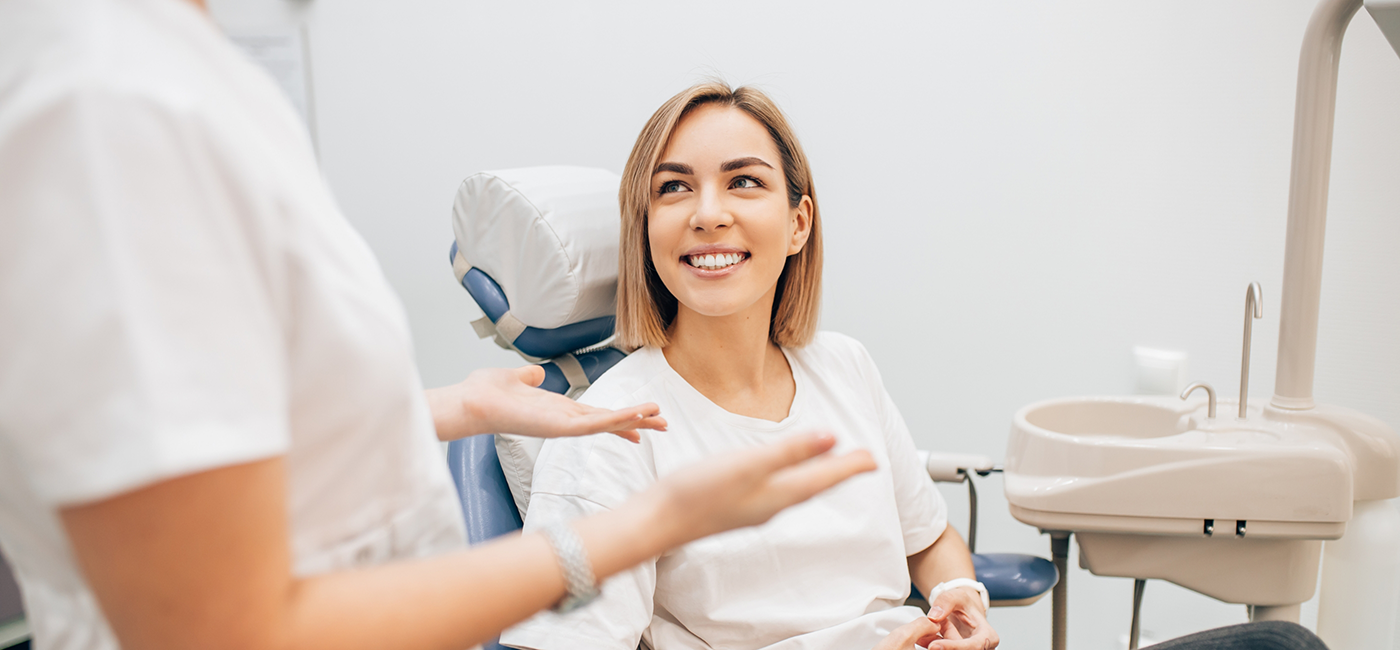 Woman listening to her dentist during a preventive dentistry checkup