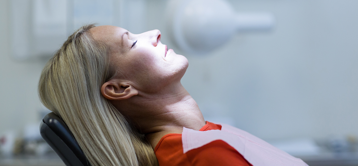 Woman relaxing in dental chair thanks to sedation dentistry in Altavista