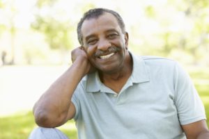 older man smiling full set teeth