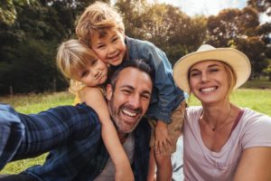 family smiling in the forest