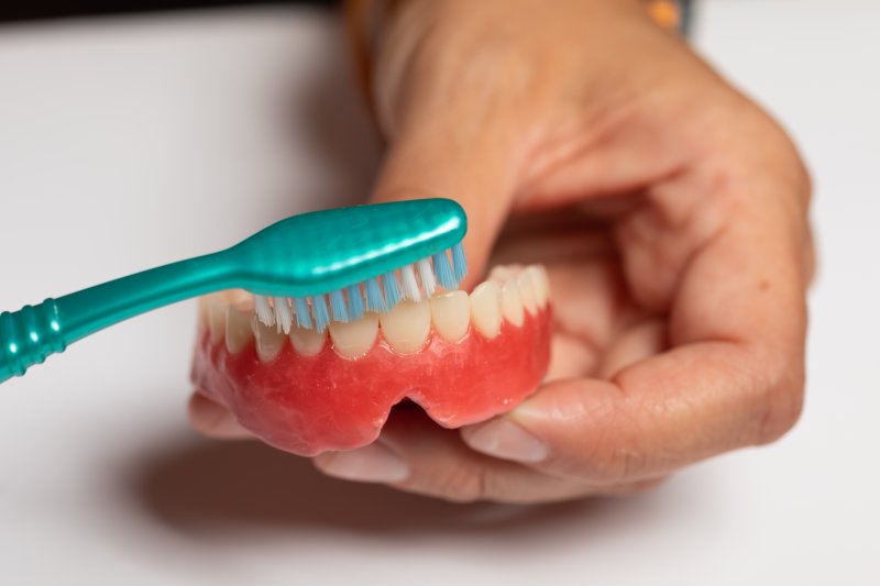 person with dentures smiling 